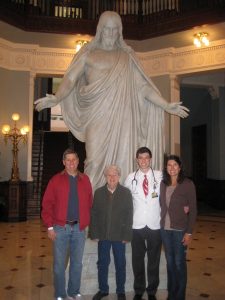 Tom Dey, Doris Klein, Jacob Dey, and Charity Dey standing with Hopkins Medicine Jesus statue