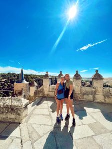 Hopkins senior women's lacrosse player Bailey Cheetham and a friend against a blue sky in Segovia, Spain