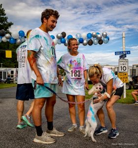 a group of gulls way color run participants with a dog at a race to raise money for the Johns Hopkins packard center for als