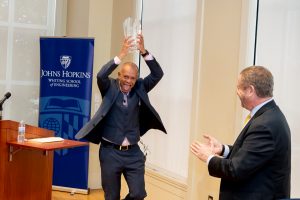johns hopkins whiting school of engineering julian s smith professor ralph etienne cummings holds a glass award over his head