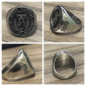 The School of Medicine silver class ring shows the MSTP crest. The left side is engraved with 2012. The right side is engraved with MD-PhD.