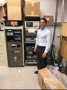 johns hopkins physics and astronomy advisory board chair noor islam stands with an old spectrometer