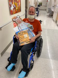 johns hopkins brain rescue unit patient bob kalbach in a wheelchair with cardboard cutouts of his granddaughter
