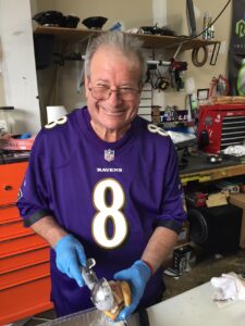 hopkins alum monroe zeffert prepares food for a ravens tailgate wearing a purple lamar jackson jersey