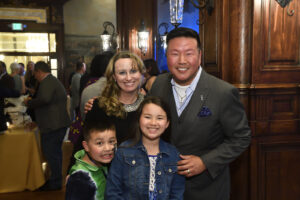 Hopkins class of 2000 alum Joe Yoon smiles with his family at Johns Hopkins reunion weekend